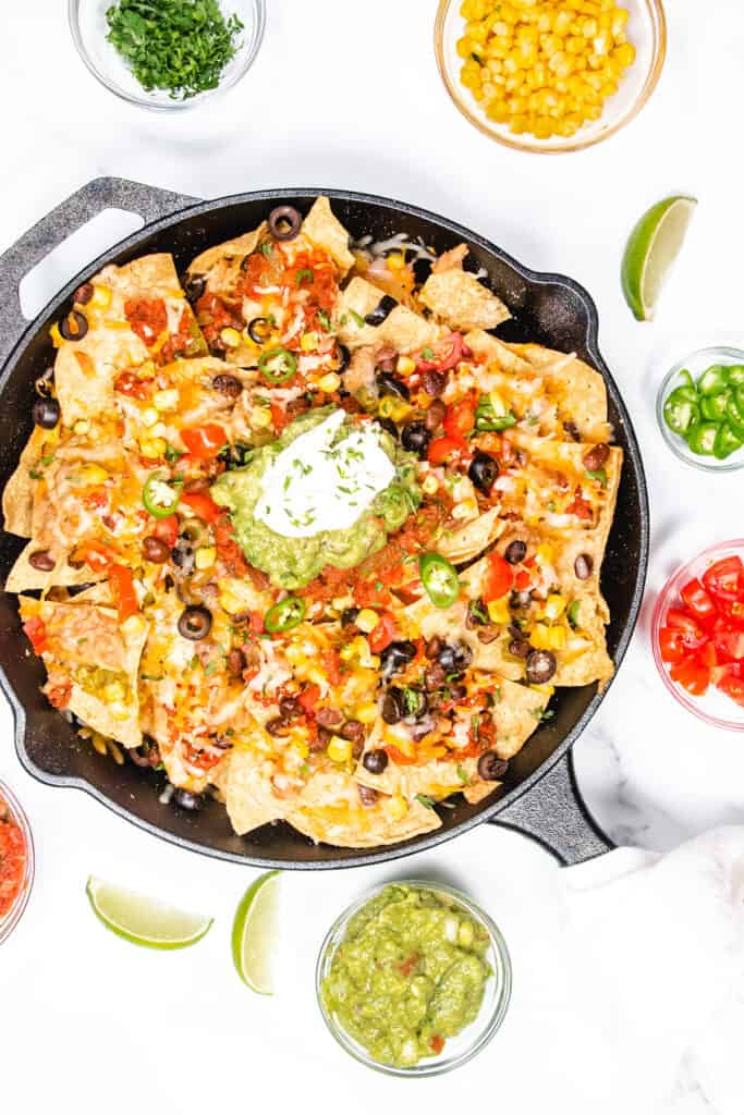 an overhead image of of a cast iron pan with nachos