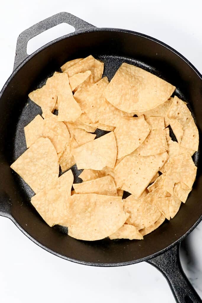 tortilla chips in a single layer in a skillet