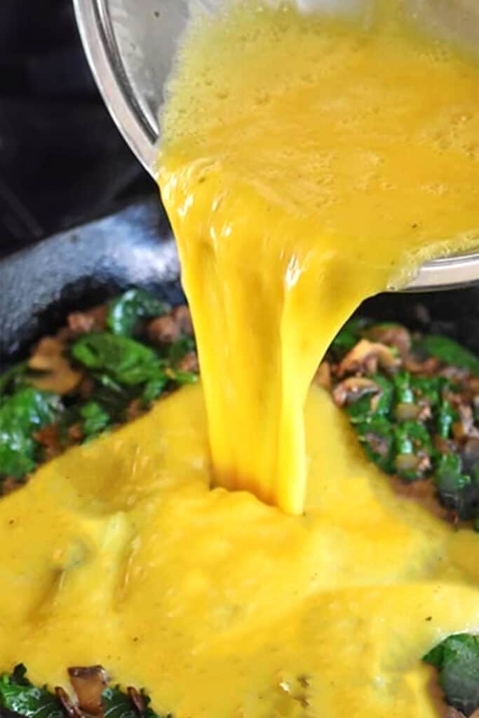 the egg mixture added to the pan with the spinach mixture