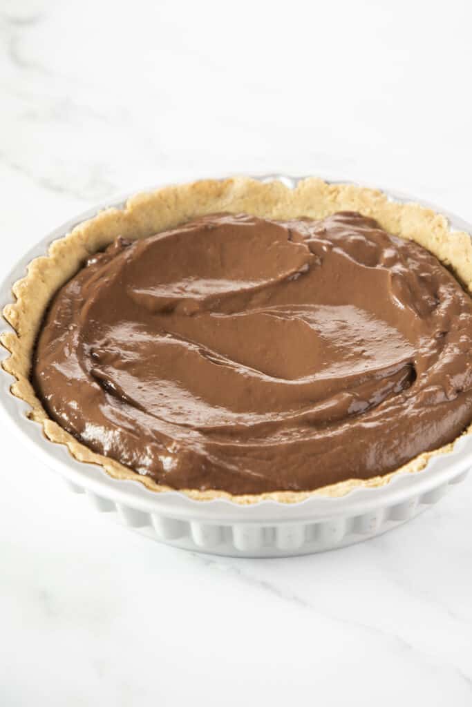 chocolate pudding added to the pie crust in the pan