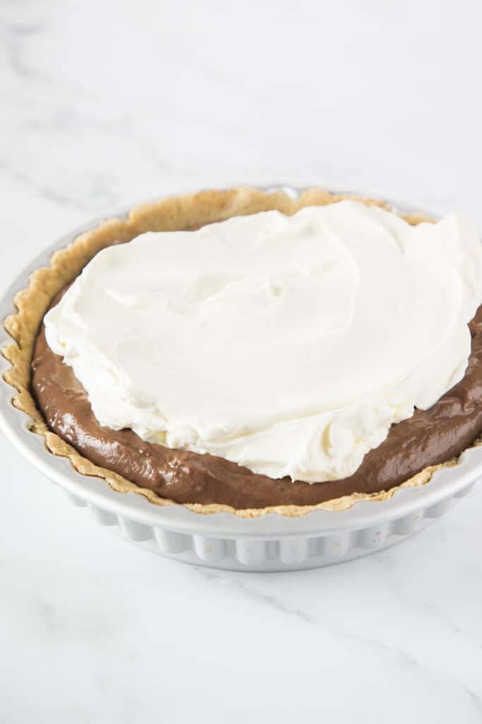 whipped cream spread onto the pudding mixture in the pan