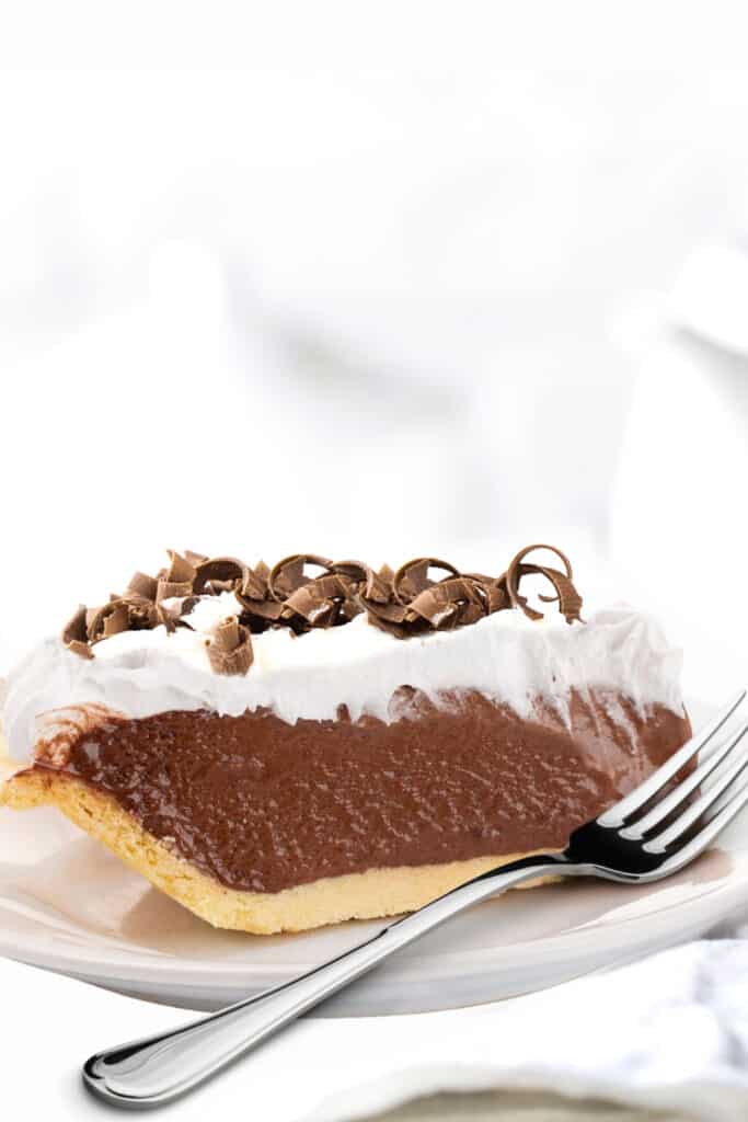 a slice of chocolate pudding pie on a plate with a fork