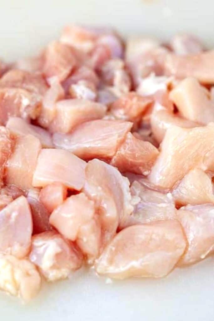 diced chicken thighs on a cutting board