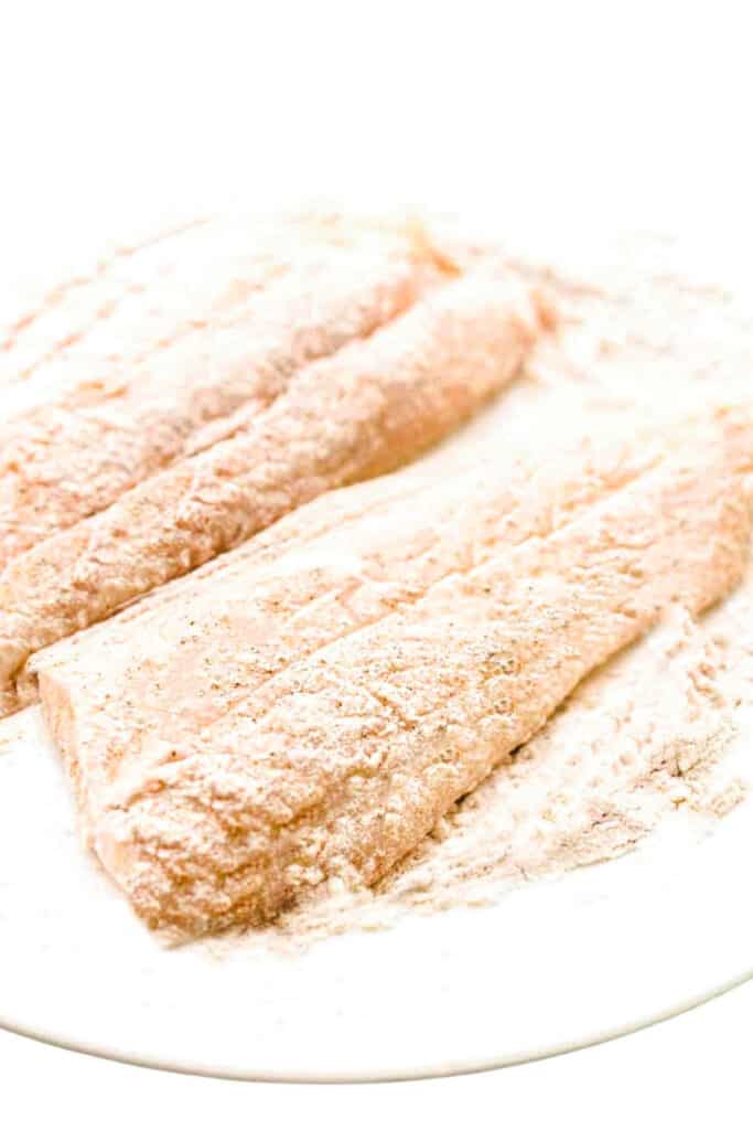 fish coated in flour on a plate