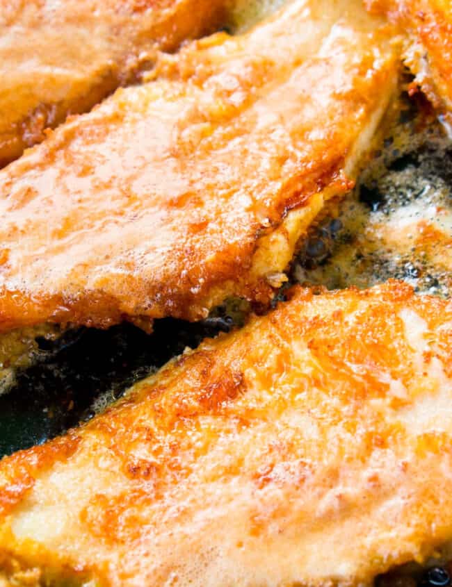 breaded fish frying in a pan