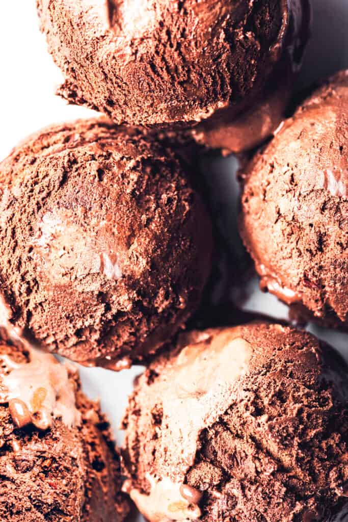 scoops of chocolate ice cream on a white plate