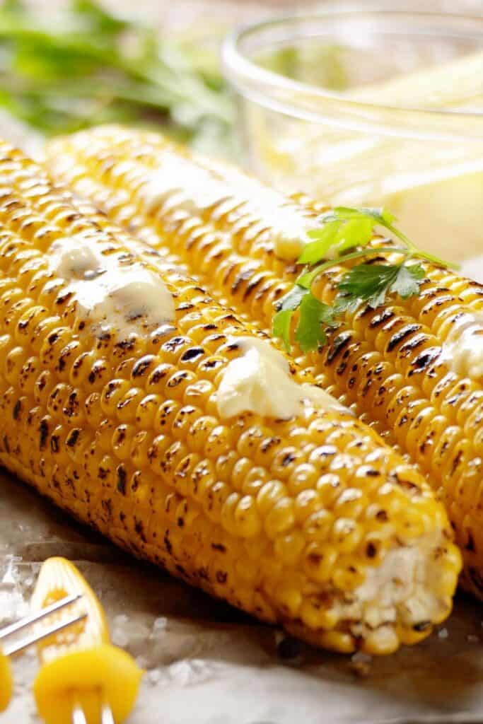 Grilled Grilled Corn On The Cob with nutter spread on it