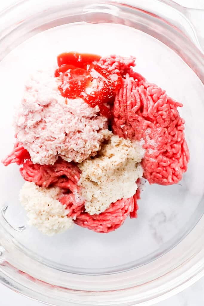 The hamburger ingredients in for The Best Hamburger Recipe in a glass bowl
