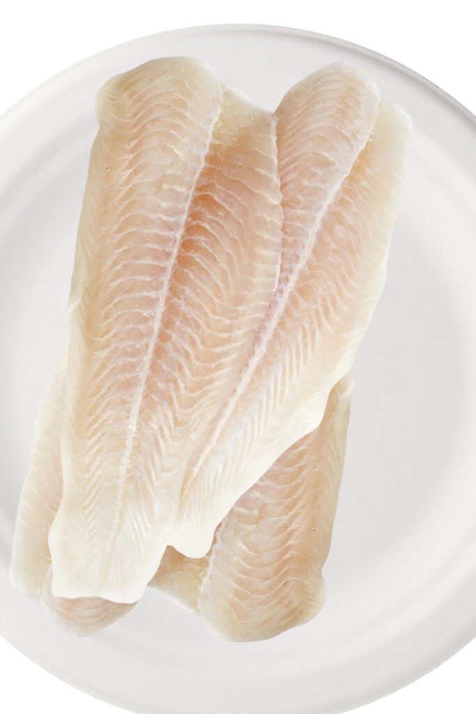 fish fillets on a white plate.