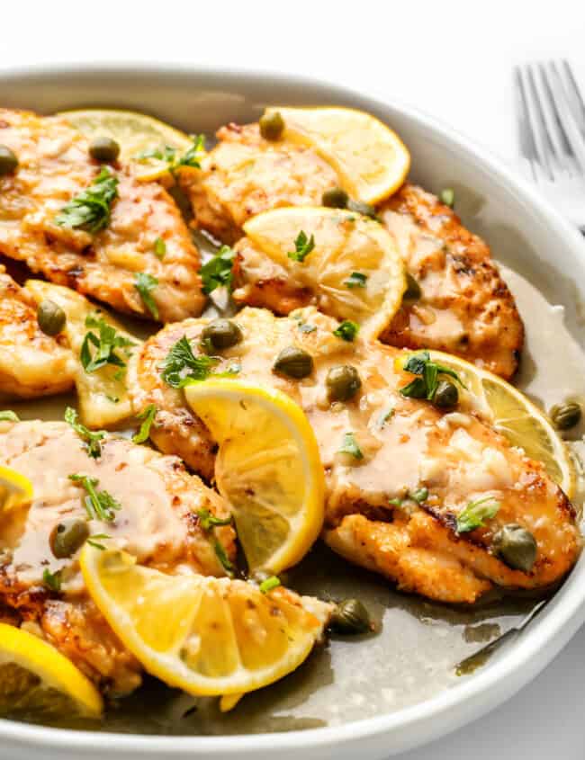 Lemon Fish Piccata garnished lemon and capers.