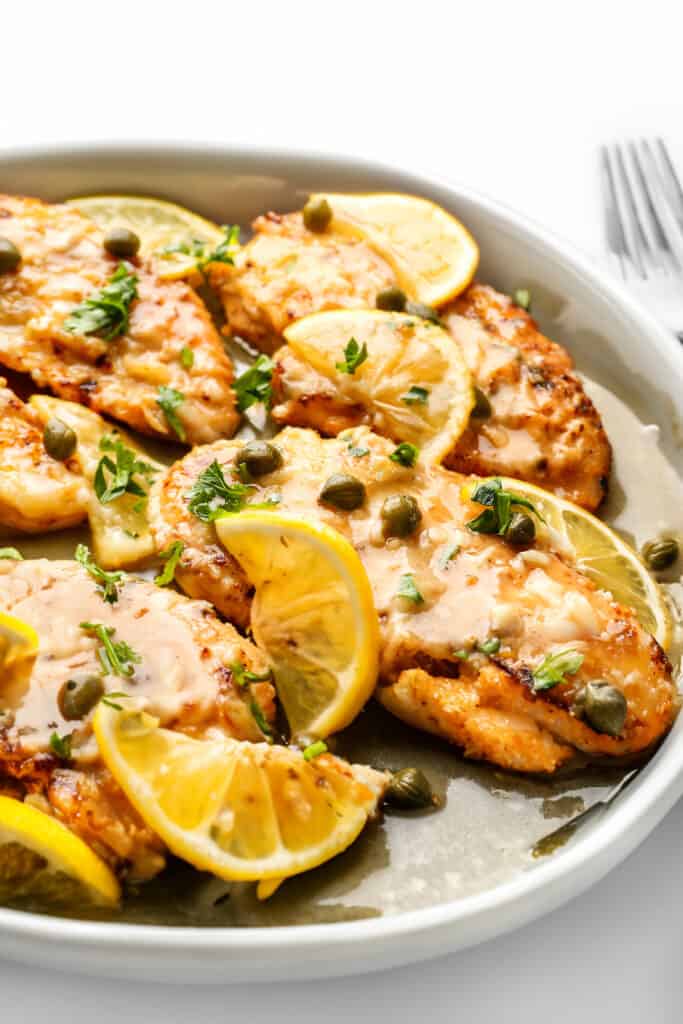 Lemon Fish Piccata garnished lemon and capers.