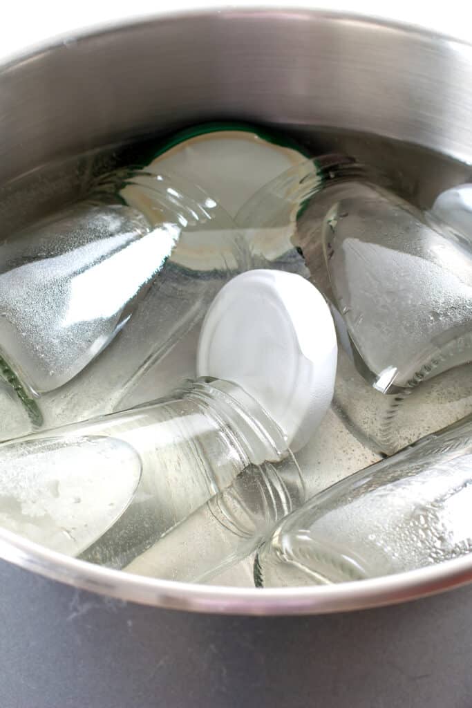 Sterilizing glass jars in a steel pan of water