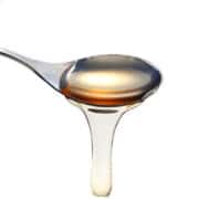 a spoon with simple syrup pouring from it