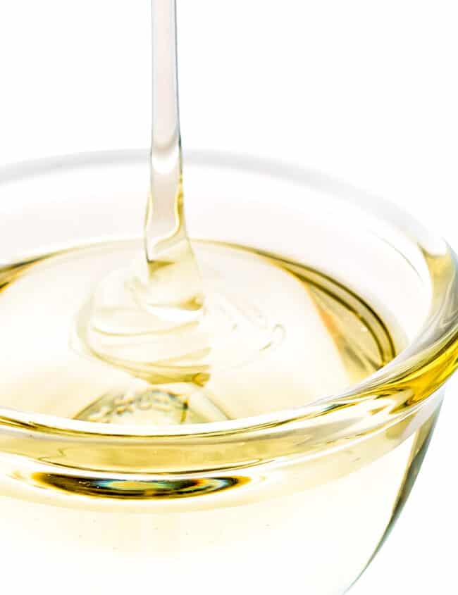 simple syrup being poured into a bowl