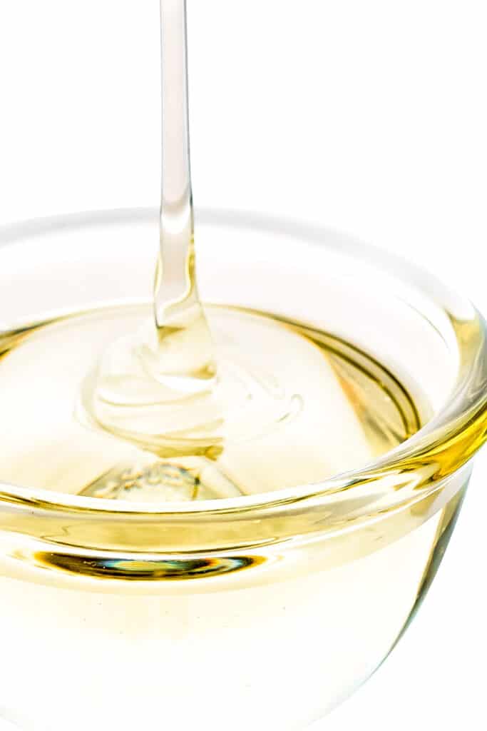 simple syrup being poured into a bowl