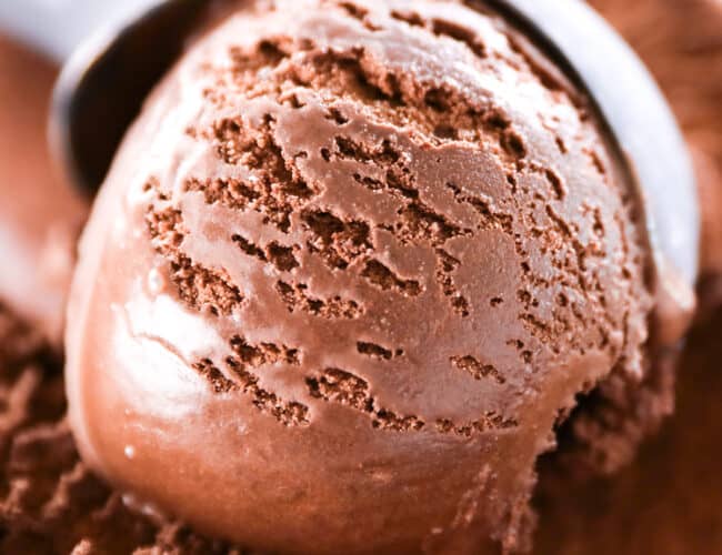 an ice cream scooper scooping Dark Chocolate Ice Cream