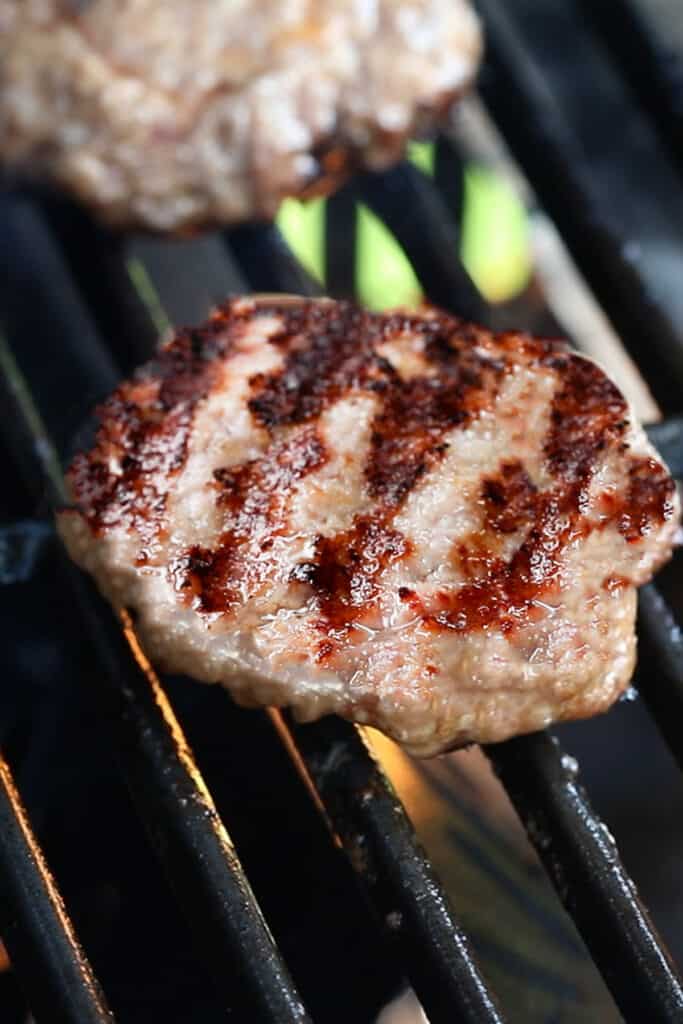 cooked pork burgers on the grill