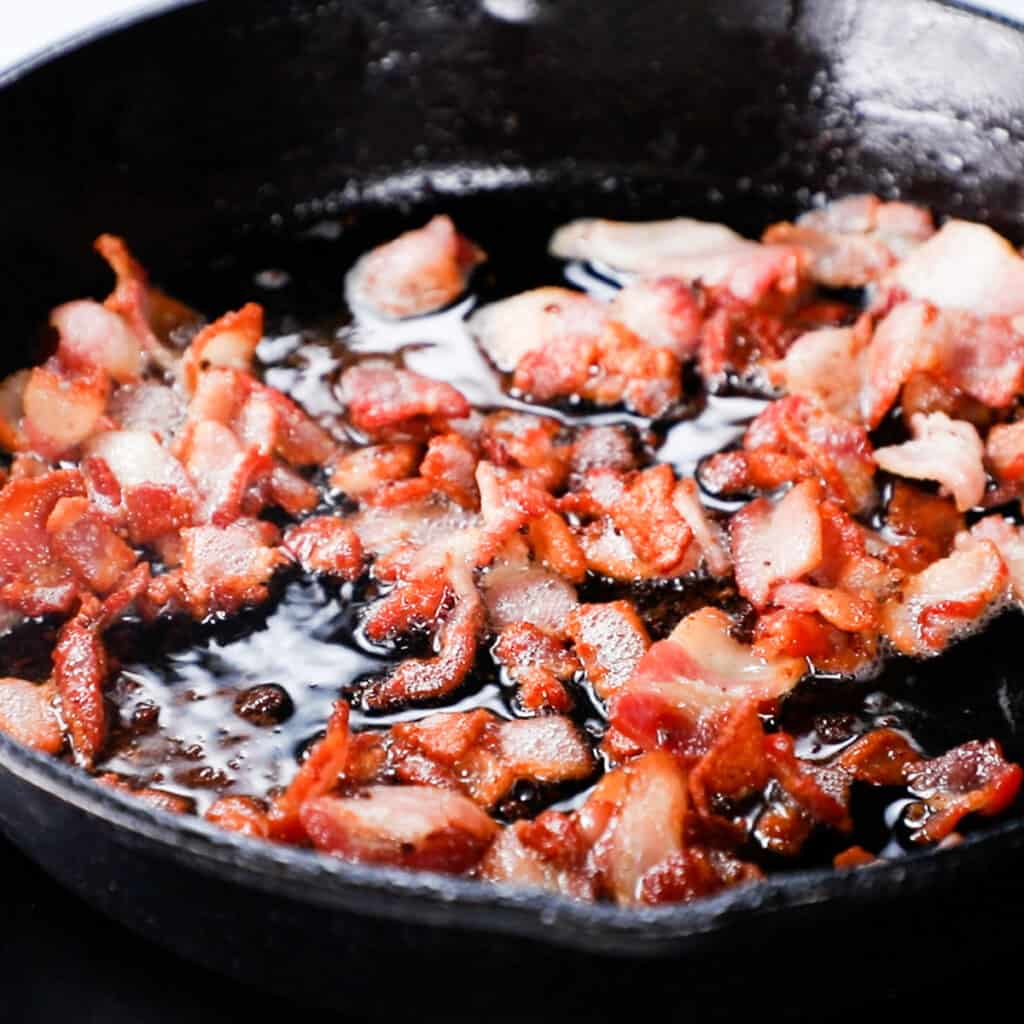 chopped bacon cooking in a skillet