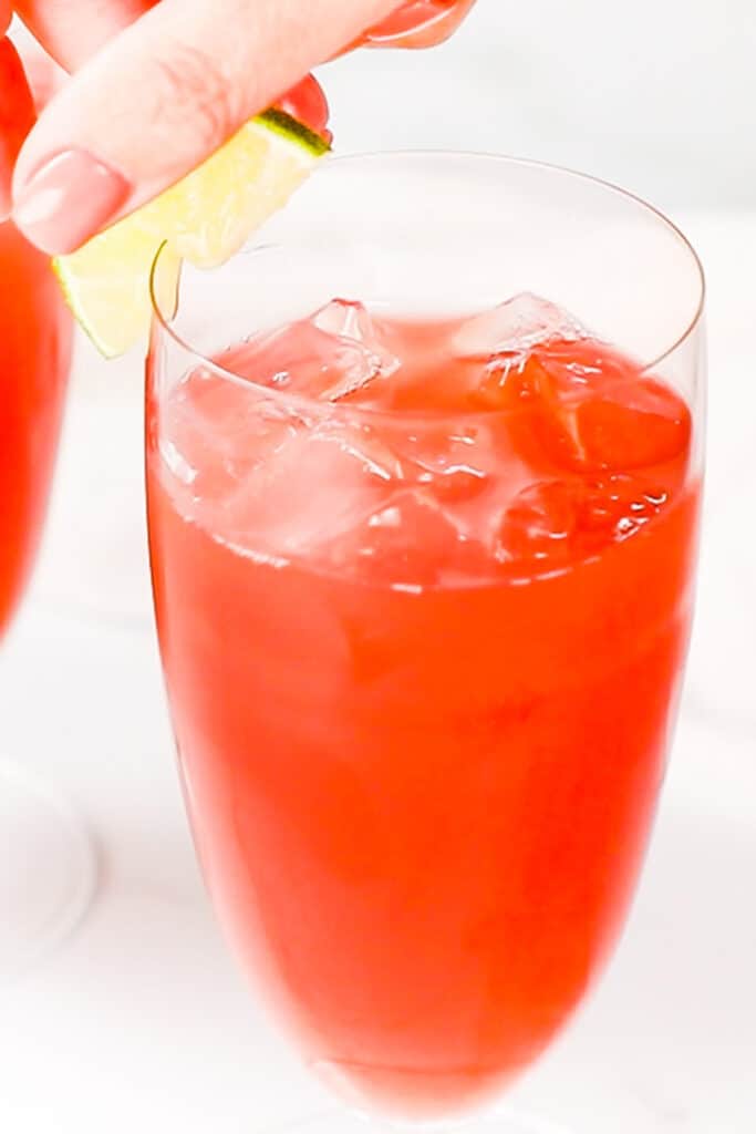 a Bay Breeze Cocktail being garnished with lime