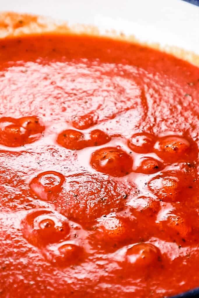 the sauce bubbling in a pan