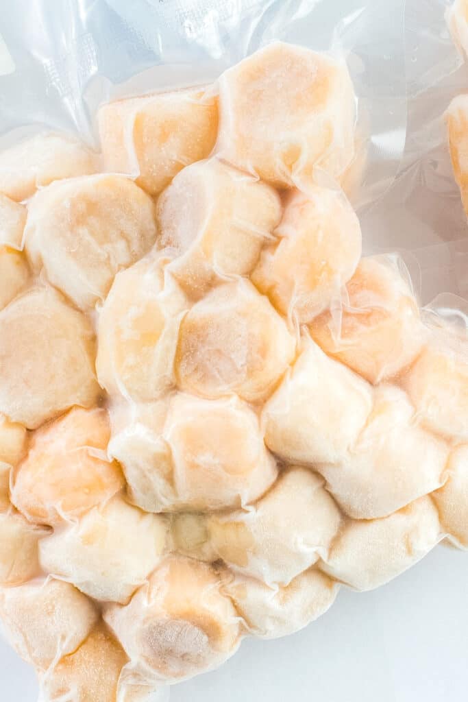 a package of frozen scallops in clear plastic