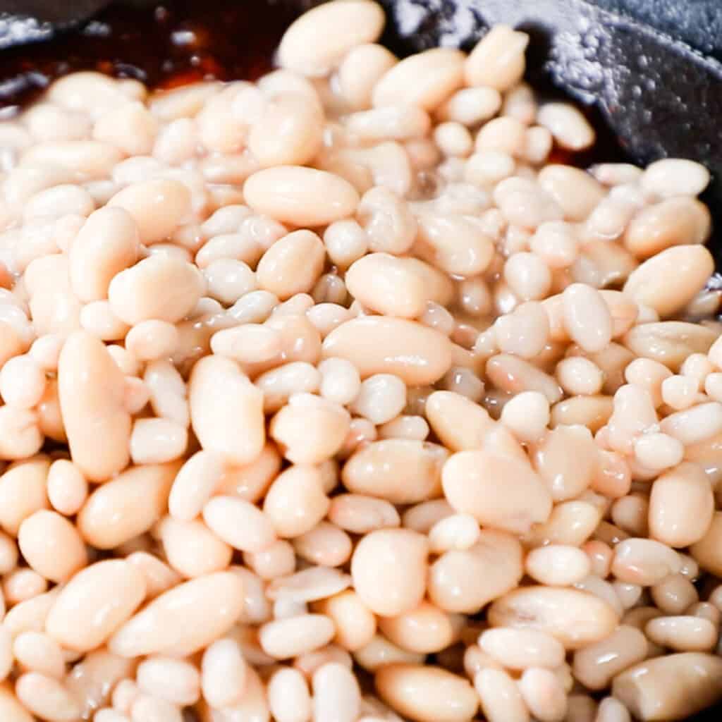 white beans in a pan of sauce