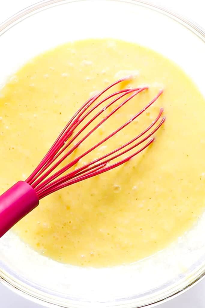 the blended egg mixture in a bowl with a whisk.