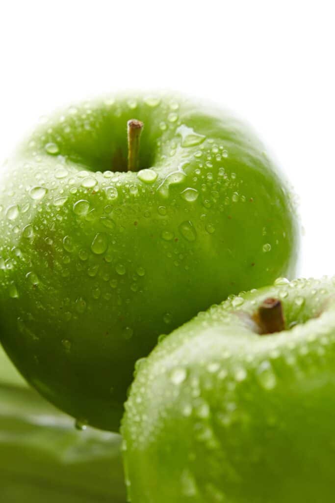 green apples with drops of water