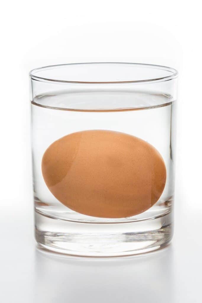 a glass of water with an egg in it
