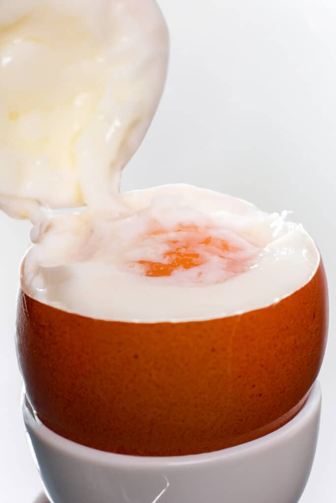 the top being removed from a cooked egg