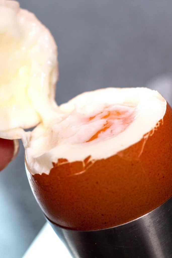 the top being removed from a cooked egg
