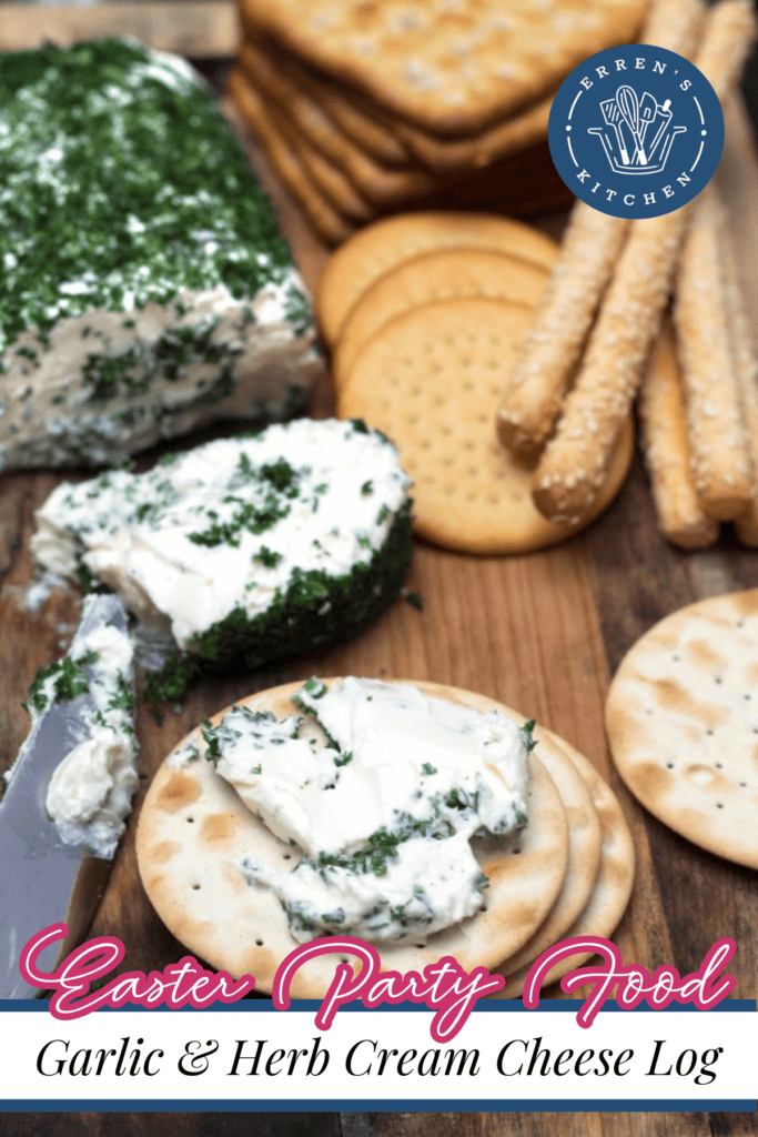 A garlic and herb cream cheese log with crackers and breadsticks.