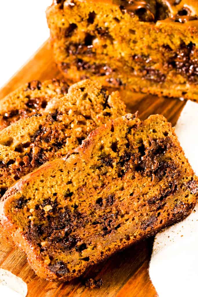 two slices of Easy Pumpkin Bread with melted chocolate chips throughout