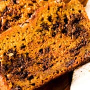 a slice of Easy Pumpkin Bread showing the melted chocolate inside the slice