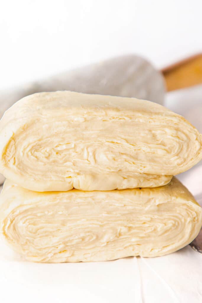 the dough cut in half showing many layers of butter.