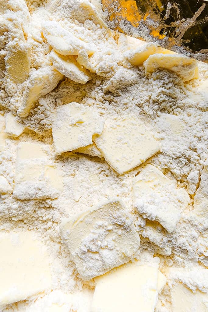 the butter tossed into the flour in a bowl