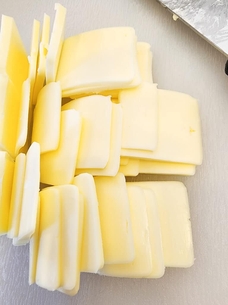 thin sliced butter on a cutting board.