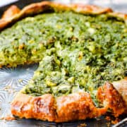 a slice of Savory Galette with Spinach and Feta on a pan