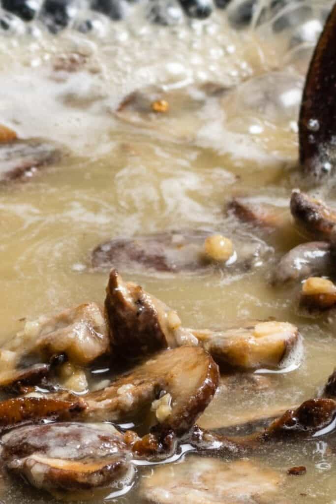 the stock added to the mushrooms in the pan