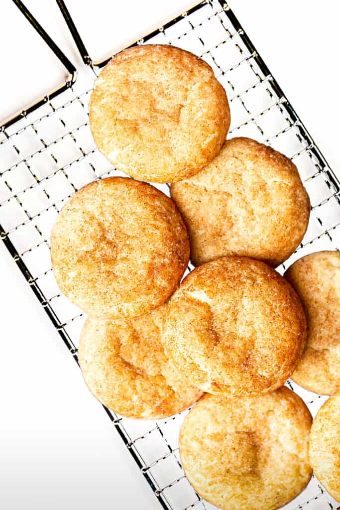 snickerdoodles made using the Best Ever Snickerdoodle Recipe stacked on a cooking rack