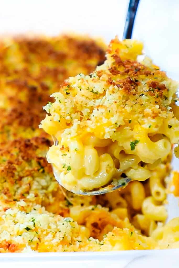 a spponful of Creamy Baked Mac & Cheese being served