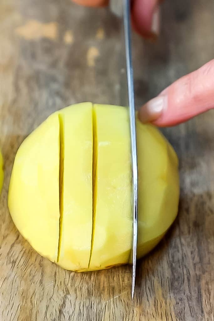 a potato being cut into sticks