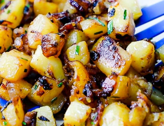 a close up image of Fried Potatoes and Onions in a skillet