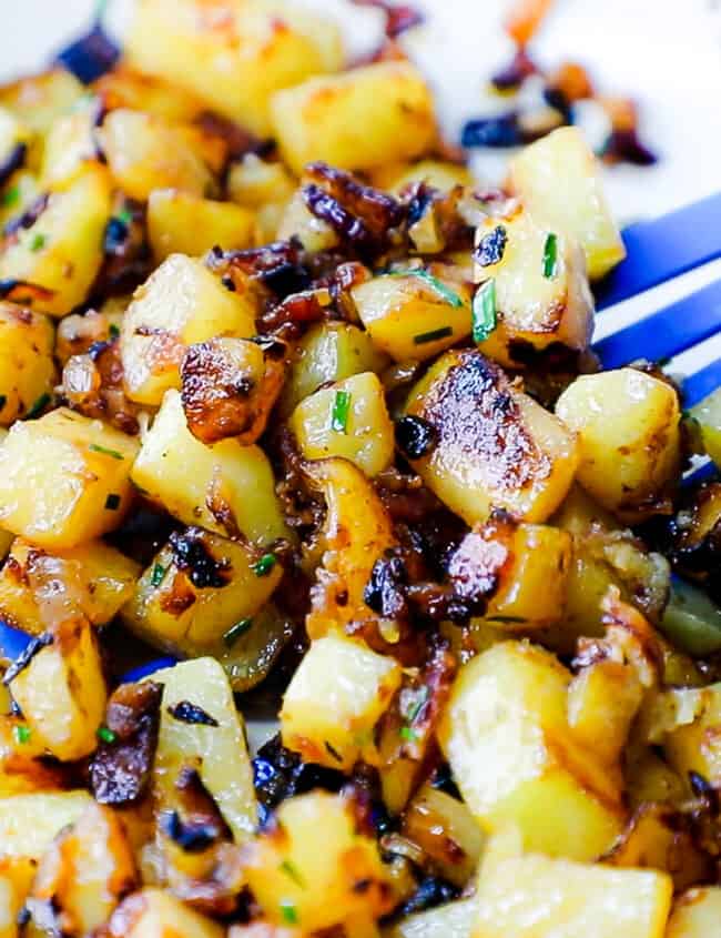 a close up image of Fried Potatoes and Onions in a skillet