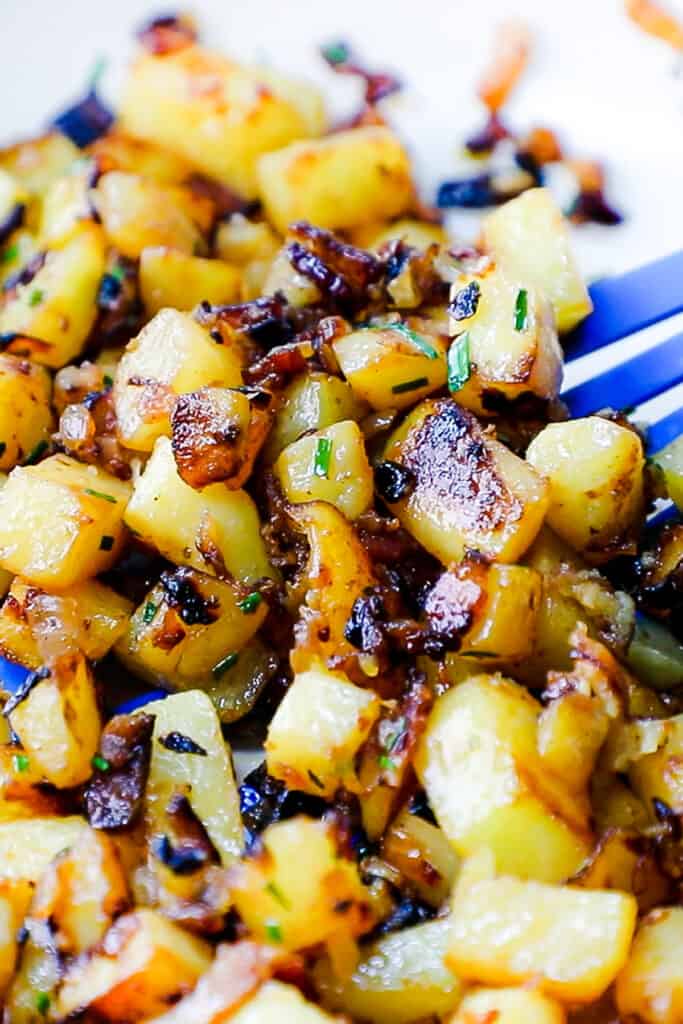 a close up image of Fried Potatoes and Onions in a skillet