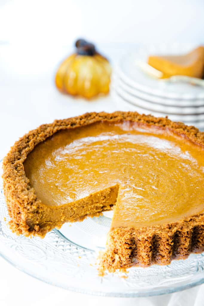 Pumpkin Pie with Graham Cracker Crust with a slice cut from it