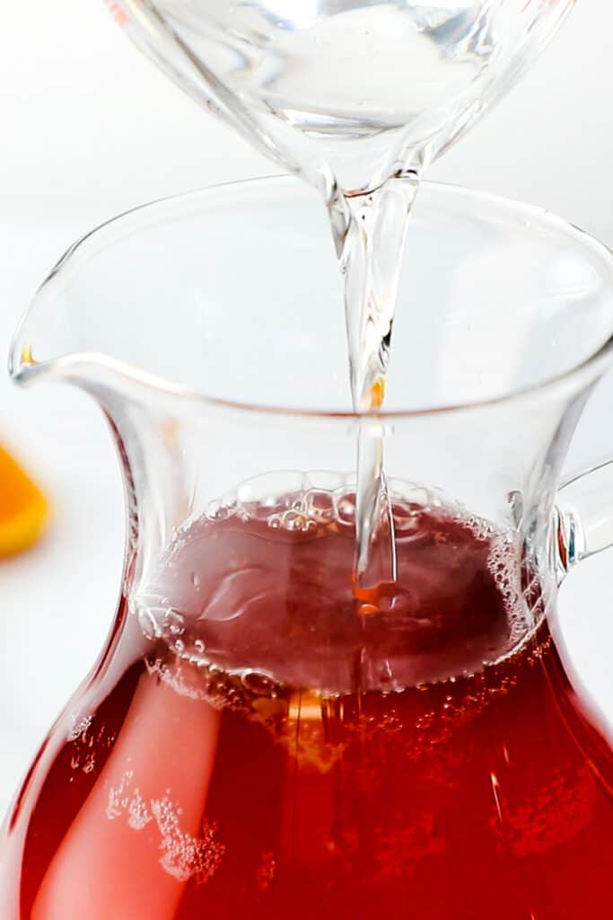 vodka pouring into the jug