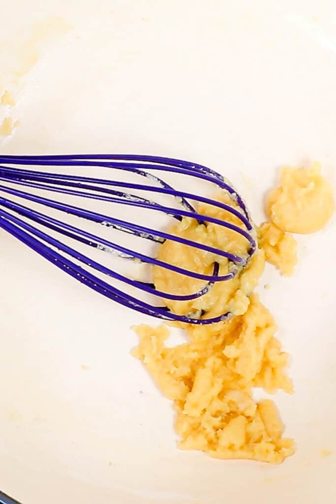 a roux being mixed with a whisk.