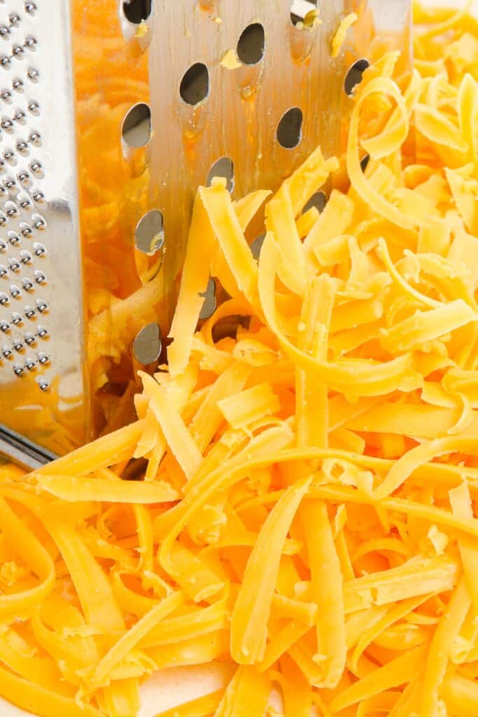 shredded cheddar cheese with a box grater.