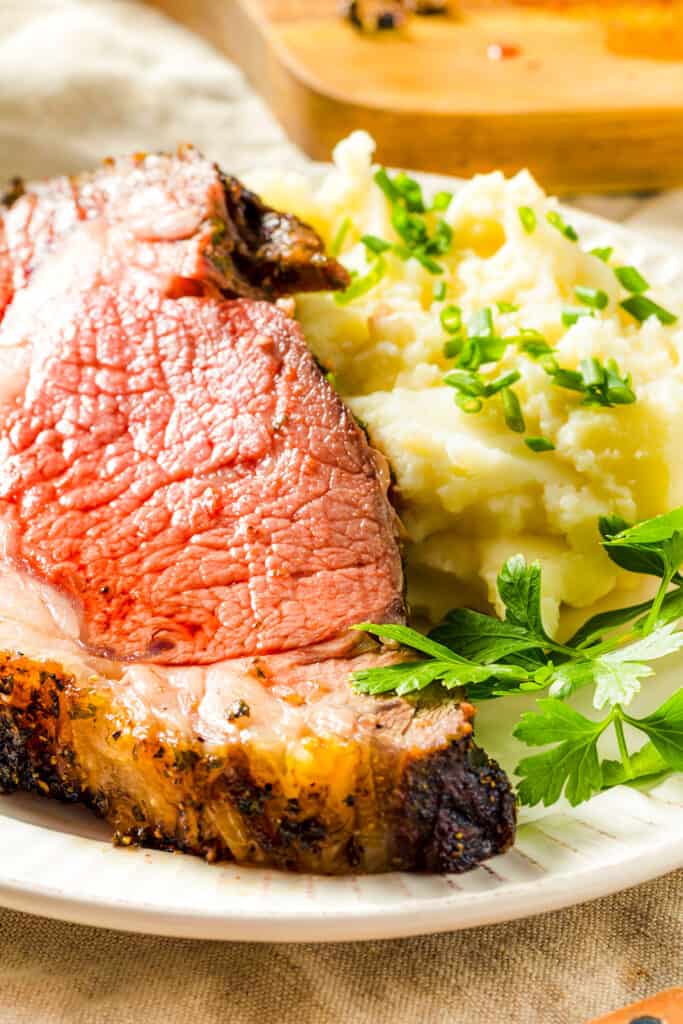 a slice of Ribeye Roast with mashed potatoes